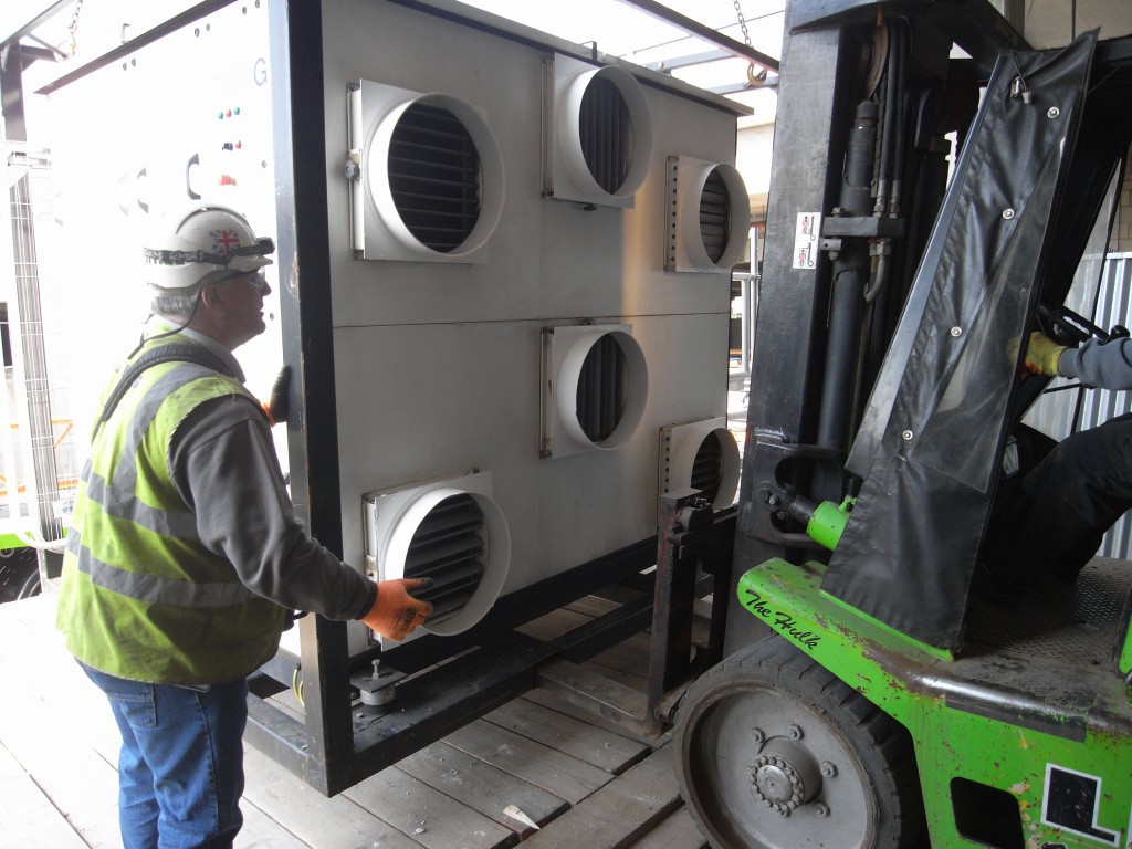 Moving and positioning of the air handling unit with a fork lift truck. The units are mounted in lifting frames for easier lifting and movement.