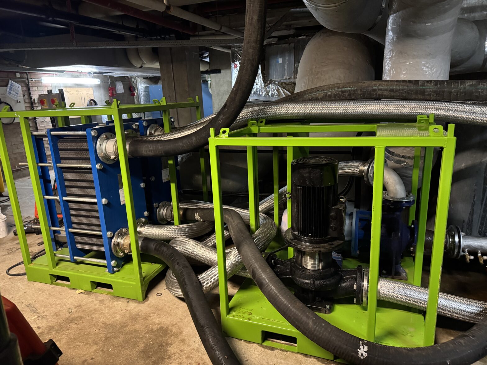 The completed temporary plate heat exchangers installation showing pipe-work connections and circulation pumps.